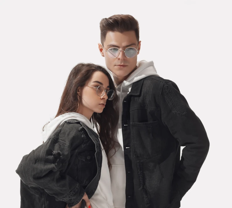 Two models wearing denim jackets and hoodies
